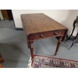 A Victorian mahogany flap sided table fitted with two drawers