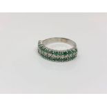 An 18ct white gold emerald and diamond half eternity ring,