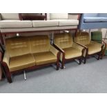 A twentieth century wooden framed three piece lounge suite in buttoned fabric