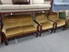 A twentieth century wooden framed three piece lounge suite in buttoned fabric