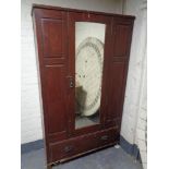 An Edwardian stained pine mirror door wardrobe (a/f)