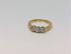 An 18ct gold three stone diamond ring, approximately 0.