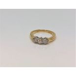 An 18ct gold three stone diamond ring, approximately 0.