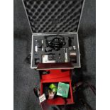 An aluminium case containing a Canon T-50 camera with lens, Kodak and Fujica camera,