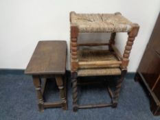 An oak stool together with two further antique rush seated stools