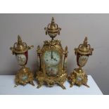 A three piece continental brass and ceramic clock garniture.