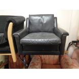 A mid century Danish black leather armchair