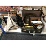 A vintage luggage case containing a quantity of mid century and later mantle and wall clocks,