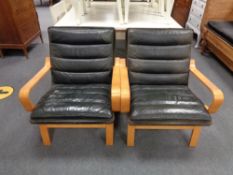 A pair of twentieth century beech framed armchairs in black leather