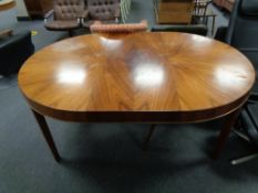 A circular mid century Danish extending dining table with leaf