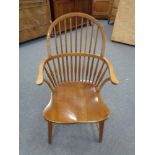 A twentieth century oak stick backed armchair