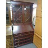 A reproduction mahogany bureau bookcase