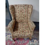 A mid century tapestry upholstered fireside chair