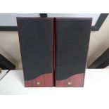 A pair of speakers in rosewood effect finish