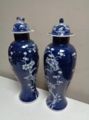 A pair of oriental blue and white lidded vases, height 38 cm.