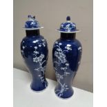 A pair of oriental blue and white lidded vases, height 38 cm.