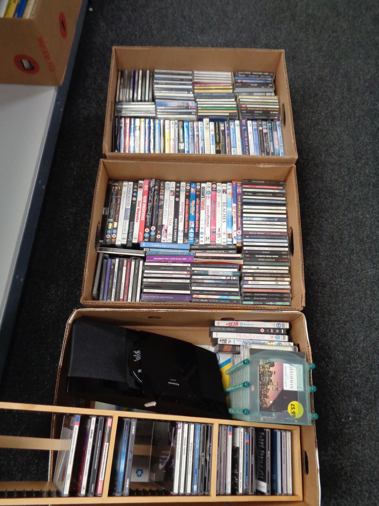 Three boxes of dvds and cds together with a Panasonic music centre