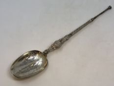 A large silver gilt copy of an anointing spoon by Elkington,