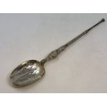 A large silver gilt copy of an anointing spoon by Elkington,