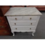 A twentieth century painted four drawer marble topped chest