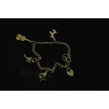 A 9ct gold bracelet with three 9ct gold charms, 10.4g gross.