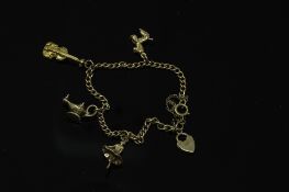 A 9ct gold bracelet with three 9ct gold charms, 10.4g gross.