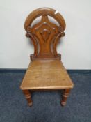 An Edwardian oak hall chair