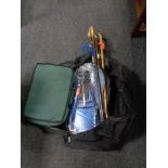 A holdall of walking sticks and umbrellas