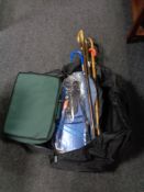 A holdall of walking sticks and umbrellas