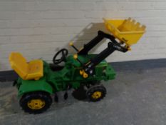A child's John Deer tractor with scoop