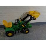 A child's John Deer tractor with scoop