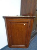 A Georgian oak hanging corner cabinet