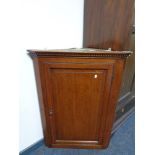 A Georgian oak hanging corner cabinet