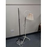 An early twentieth century painted cast iron extending floor lamp and one other