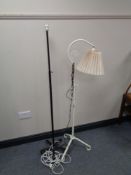 An early twentieth century painted cast iron extending floor lamp and one other