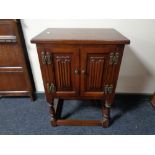 An Old Charm double door cabinet on raised legs