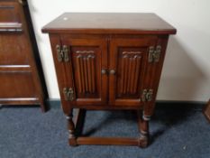 An Old Charm double door cabinet on raised legs