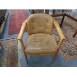 A twentieth century beech framed armchair in tan buttoned leather