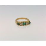 An 18ct gold emerald and diamond ring, approximately 0.