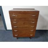 A mid century teak five drawer chest
