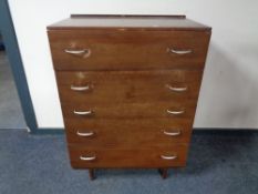 A mid century teak five drawer chest