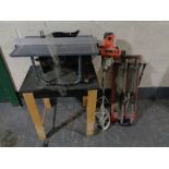 An electric table saw on stand together with a cement mixer and tile cutter CONDITION