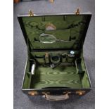 A Twentieth Century black vanity case with a fitted interior and lined with green satin,