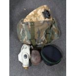 A military style camo bag containing WW II water bottle, gas mask,