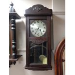 A 1930's wall clock with silvered dial,