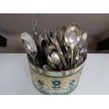 A tin of plated cutlery