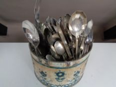 A tin of plated cutlery
