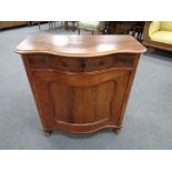 A late nineteenth century mahogany serpentine fronted cabinet