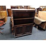 A set of Edwardian oak bookshelves with cupboard beneath