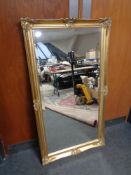 A gilt framed bevelled overmantel mirror